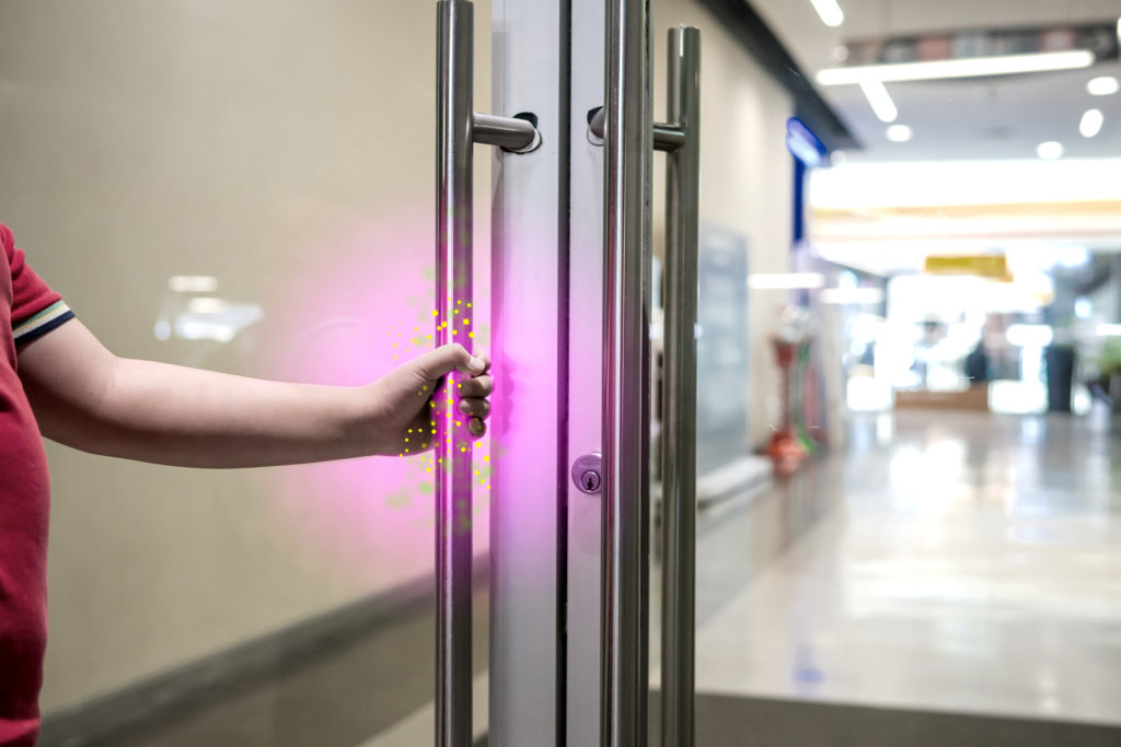 Commercial door with bacteria and germs needs disinfection