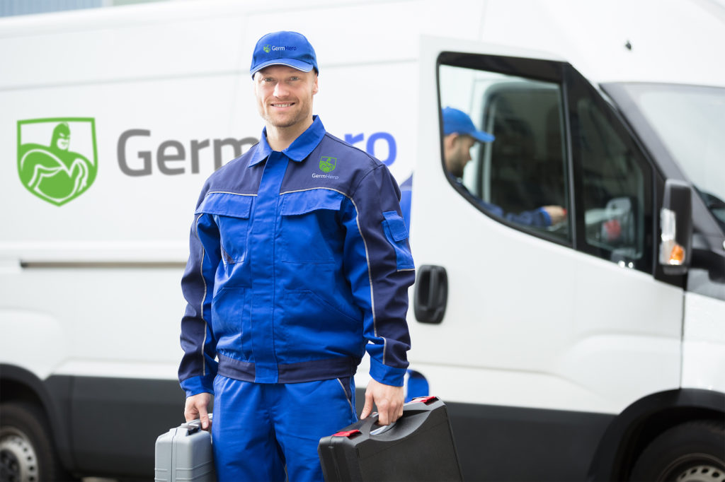 Germ Hero Technician Smiling in front of Germ Hero Truck